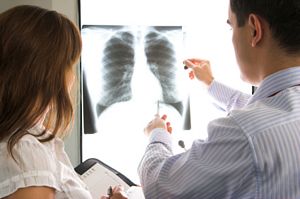 doctors consulting over a chest x-ray
